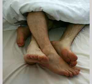 Cuatro pies asomando debajo de las sábanas